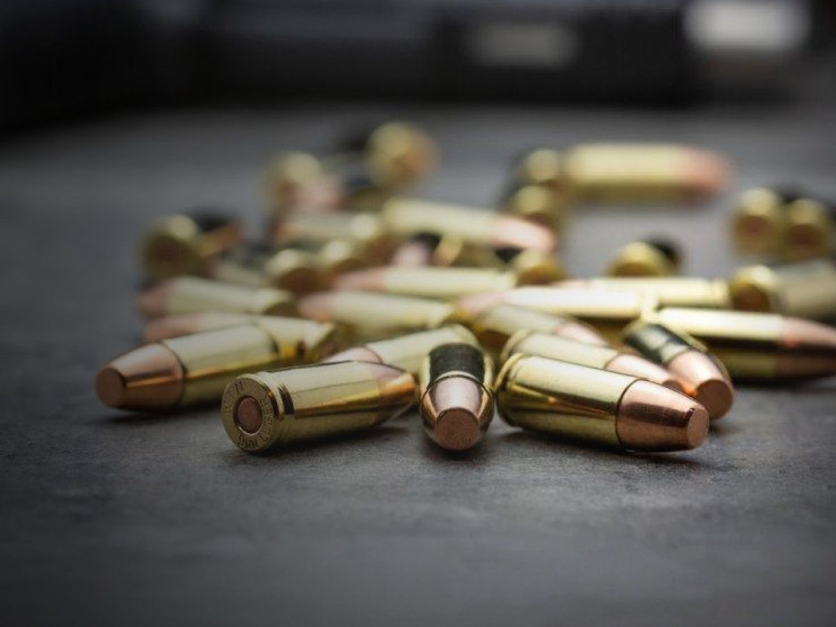 Loose 9mm cartridges on a slate bench